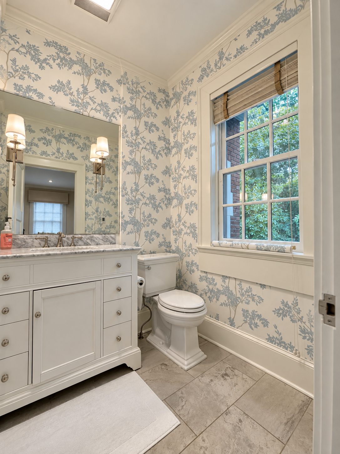 Bright white-and-blue floral wallpaper installation in a powder room in Sandy Springs GA
