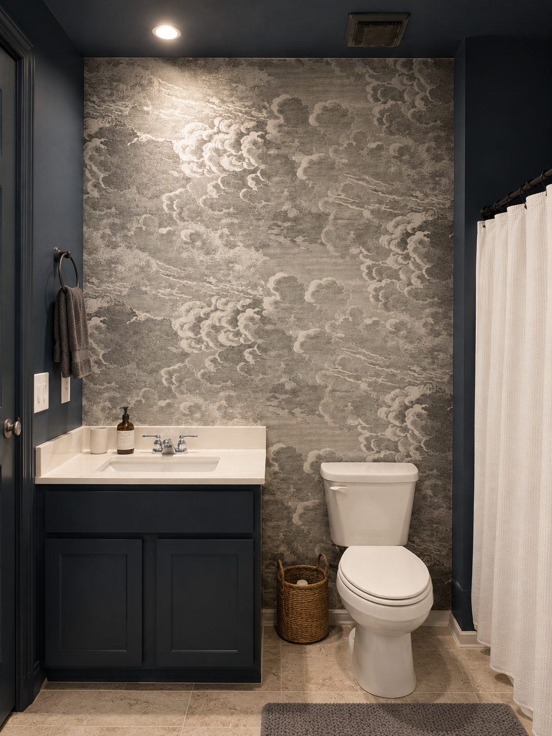 Grey cloud mural wallpaper in a navy bathroom
